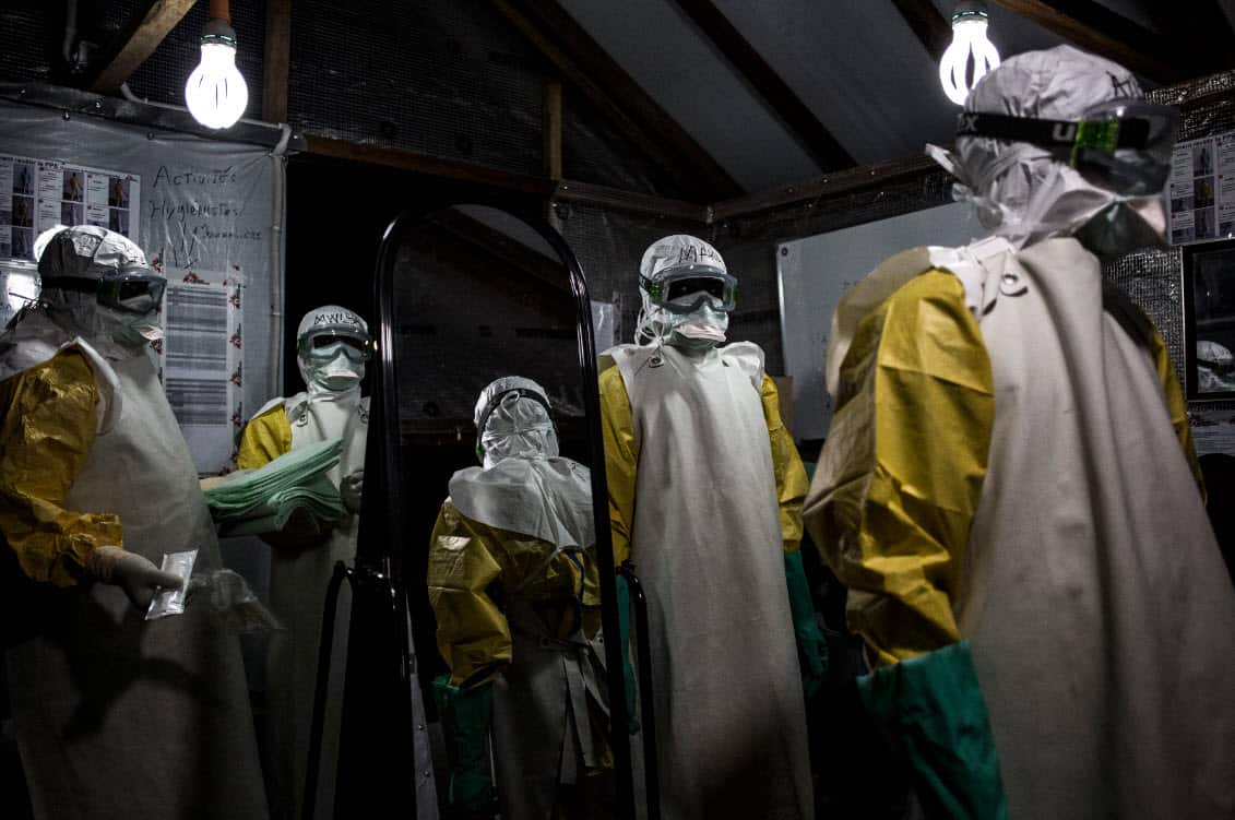 Health workers are seen putting on their personal protective equipment before entering the red zone of a Medecins Sans Frontieres (MSF) supported Ebola treatment centres (AAP)