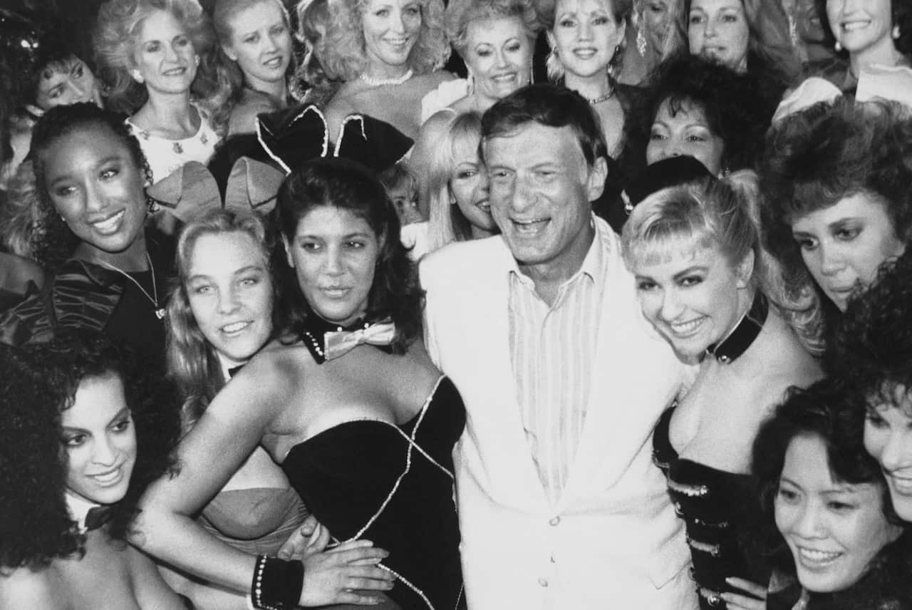 1986 file photo of Hefner, center, with a group of Playboy bunnies at the Playboy Club (AAP)