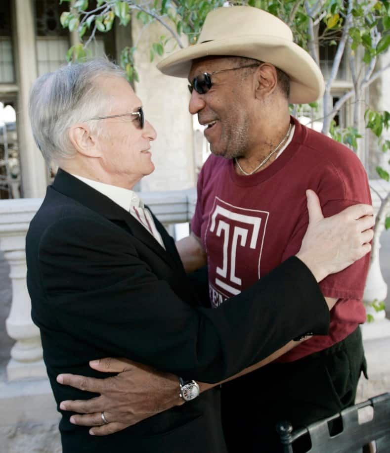 Bill Cosby, perennial host of the Playboy Jazz Festival, right, and Playboy impresario Hugh Hefner greet each other in 2008 (AAP) 