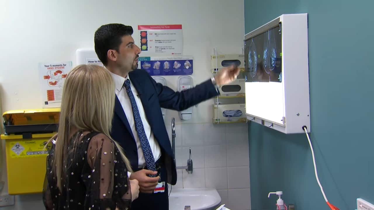 Dr Helat and Ms Fadel look over her scans.