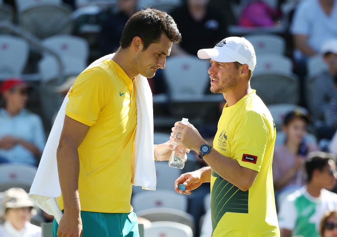 Bernard Tomic speaks with team captain Lleyton Hewitt during his Davis Cup tennis match in 2016.