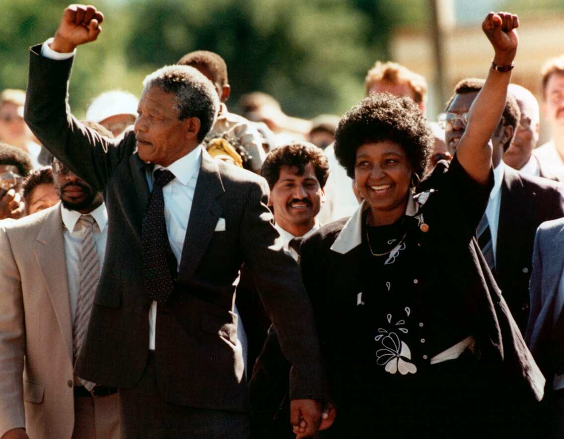 Nelson Mandela and wife Winnie, walk hand in hand, raising their clenched fists upon his release from prison.