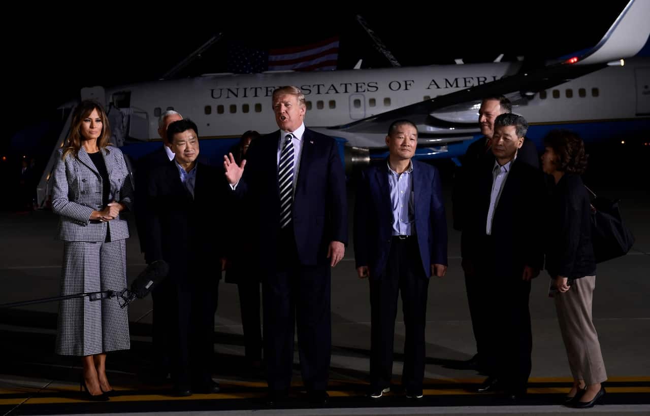 President Donald Trump, center, speaks as he greets Tony Kim, second left, Kim Dong Chul, fourth right, and Kim Hak Song, second right