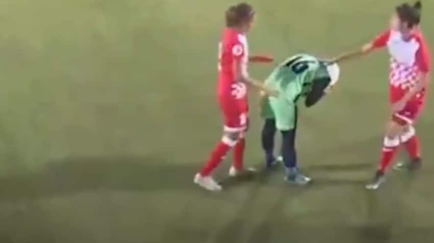 Rather than chasing the ball, players were quick to stop and huddle around her. 