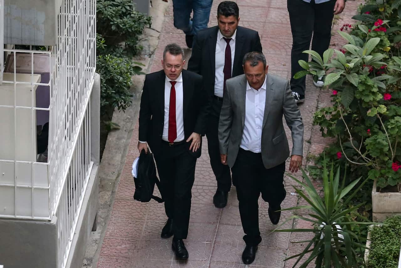 US Pastor Andrew Brunson, front left, arrives at home after his release