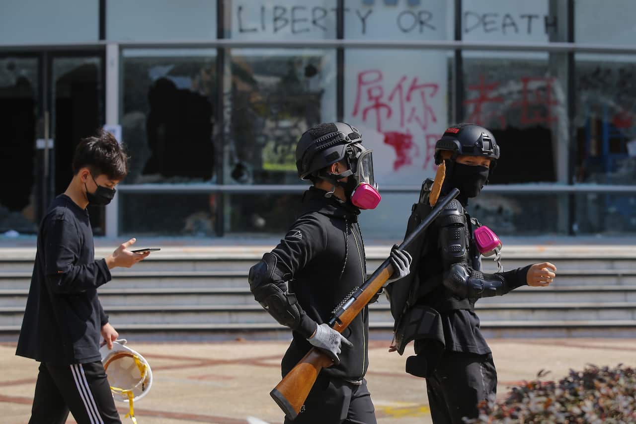 Pro-democracy protesters walk outside the Hong Kong Polytechnic University. 