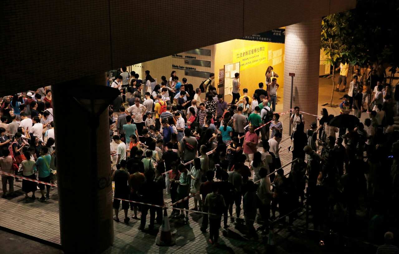 People queue at a polling station to vote for the legislative council election Sunday, Sept. 4, 2016. (AAP)