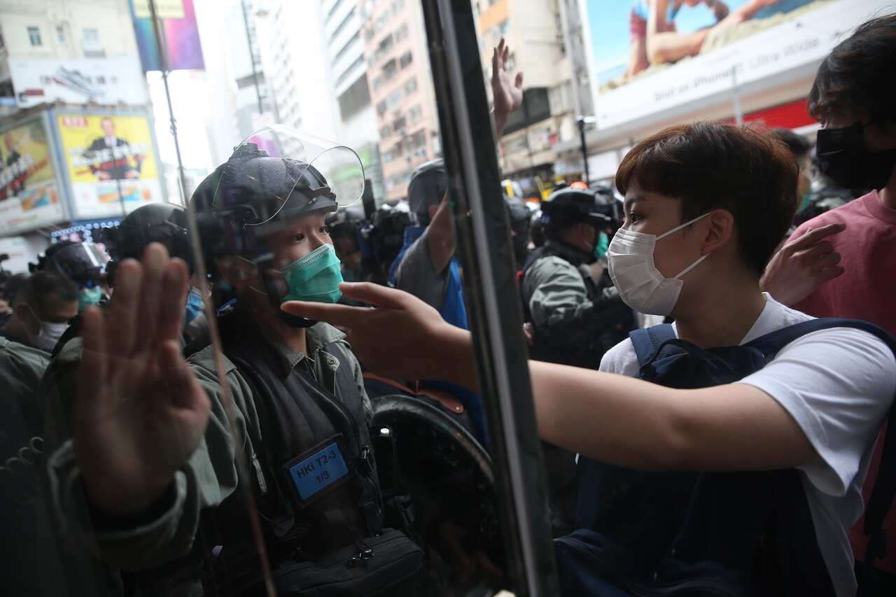 Police attempt to disperse protesters angry over China's new security law.