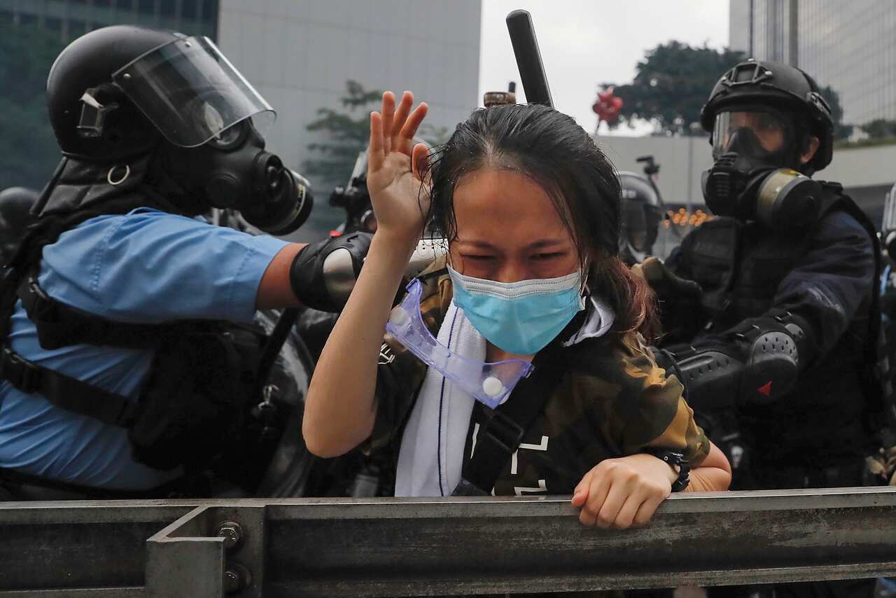 A protester is confronted by riot police during a massive demonstration outside the Legislative Council in Hong Kong on Wednesday.