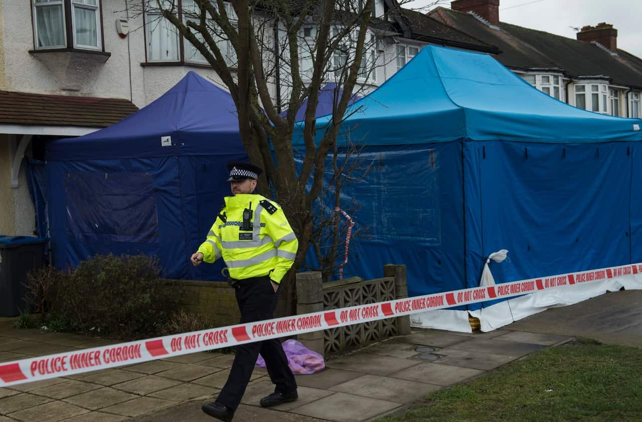 A police officer outside the scene of a property where the body of Russian businessman Nikolai Glushkov was found in New Malden, South London, Britain