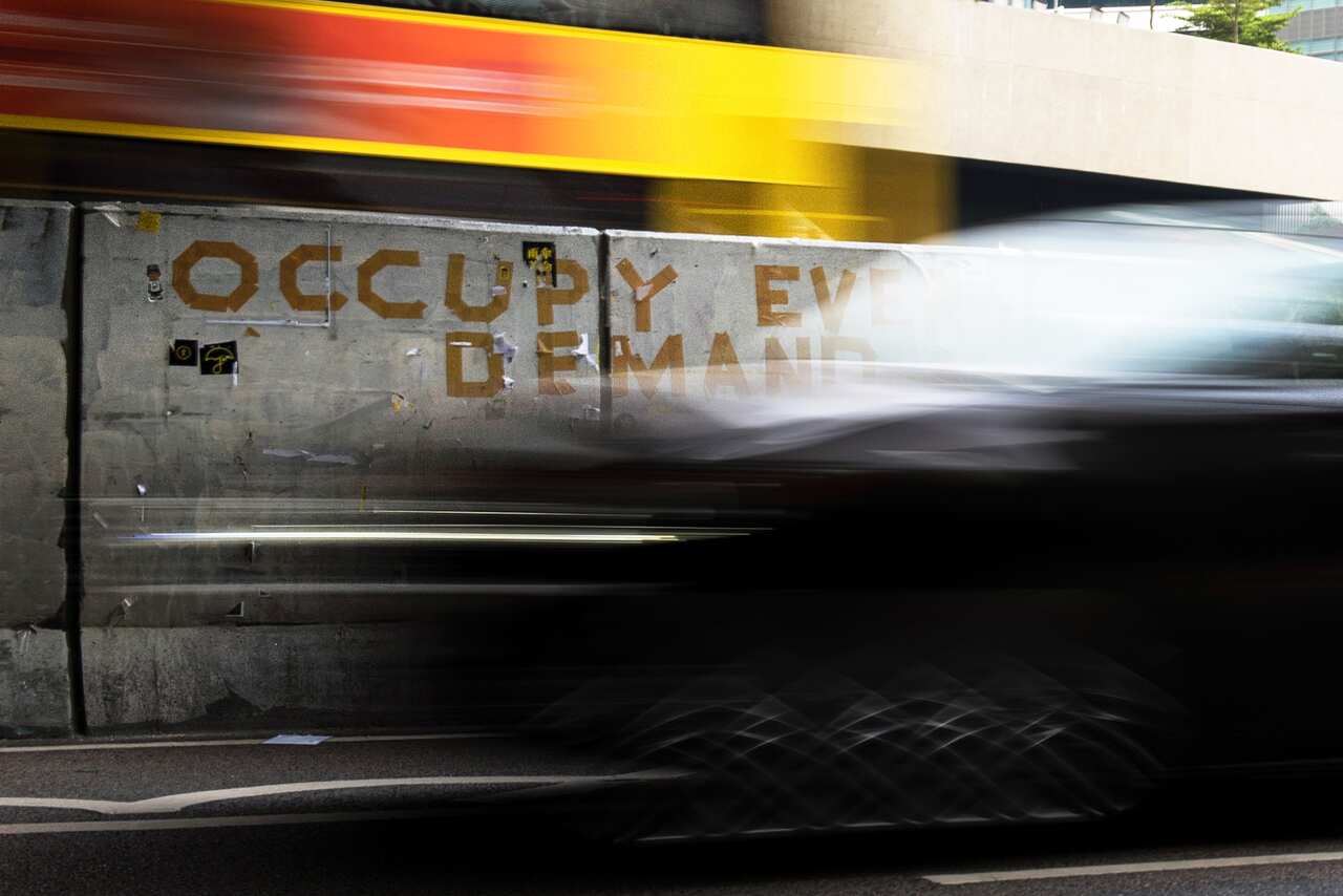 Traffic drives past a message from the pro-democracy Occupy movement in the Admiralty district of Hong Kong. (AFP/Getty)