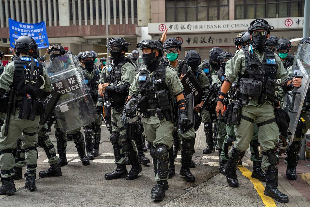 Anti-riot police disperse a crowd of protesters.