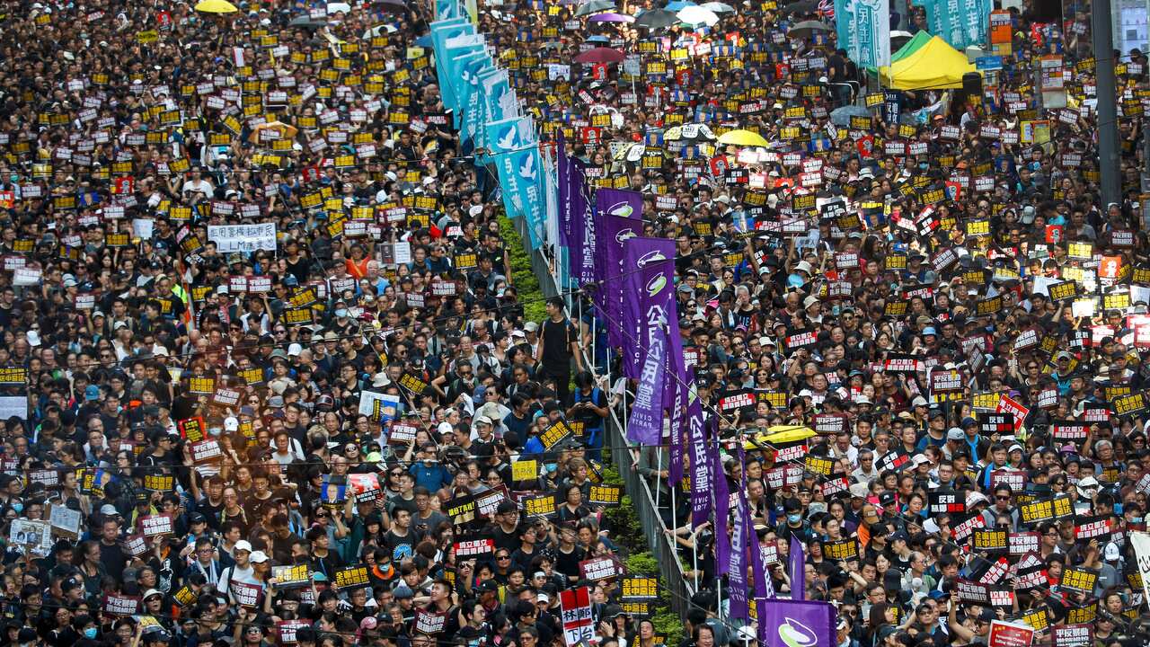 Protesters take part in a march on a street in Hong Kong, 21 July 2019.  
