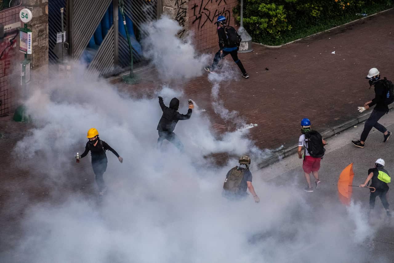 Riot police officers fire teargas during clashes with protestors in the Wong Tai Sin District district of Hong Kong, on Monday, Aug. 5, 2019. A top Chinese official overseeing Hong Kong affairs said on Wednesday that the city was experiencing its worst cr