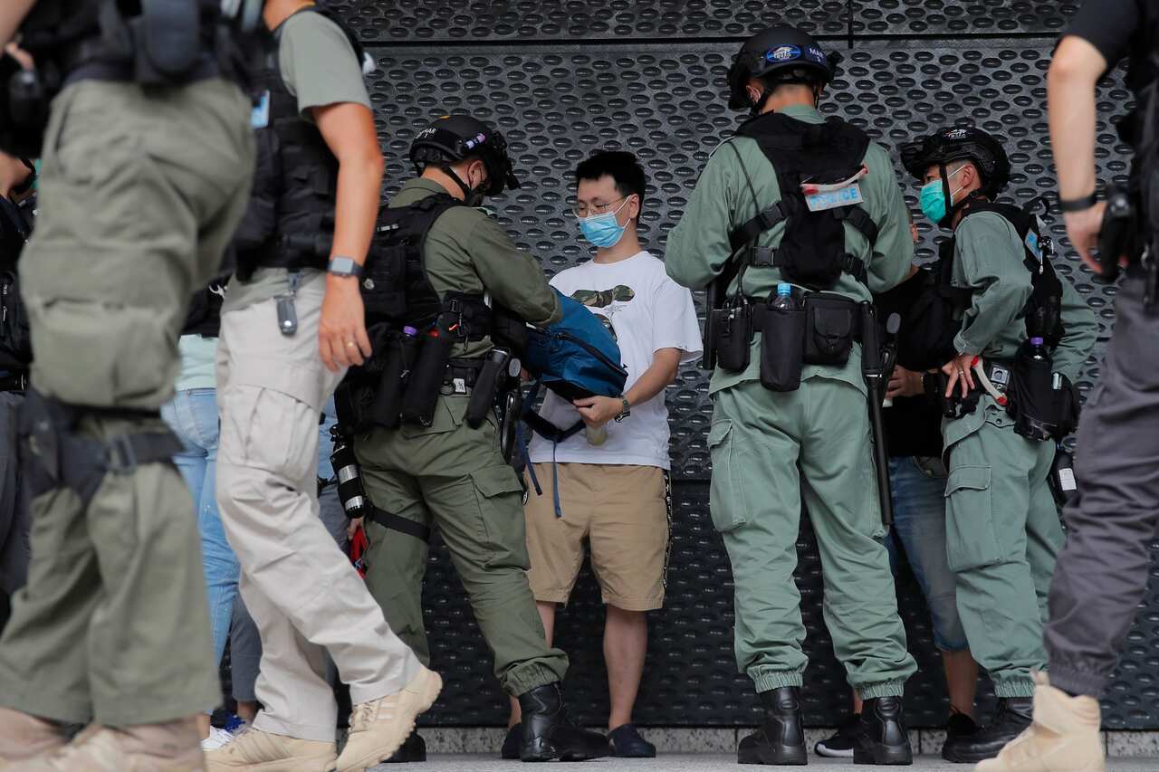 Riot police questions a man near the US Consulate in Hong Kong on 4 July, 2020.