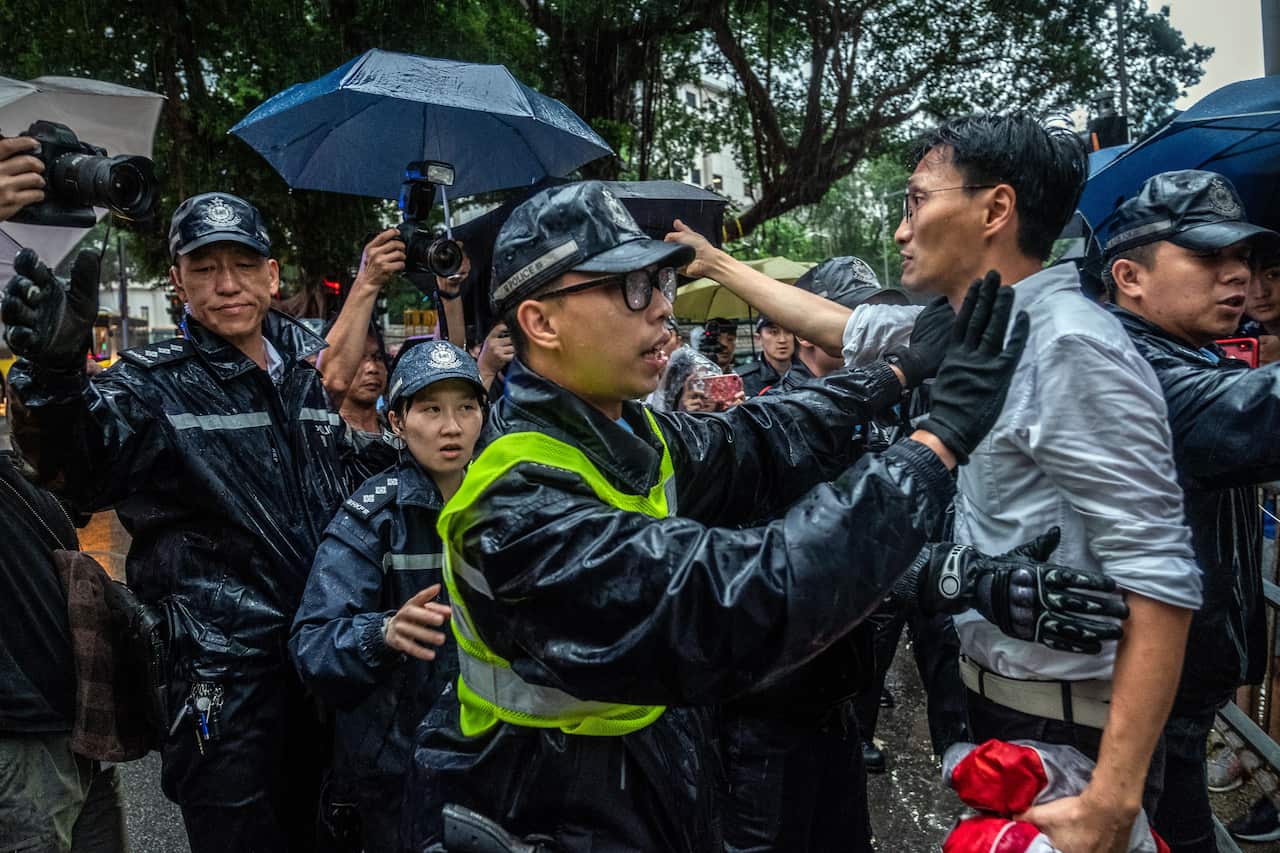 Police officers block the politician Eddie Chu during a pro-democracy lawmakers march to the residence of Hong Kongs leader, Carrie Lam, on Thursday, June 13, 2019. (Lam Yik Fei/The New York Times)