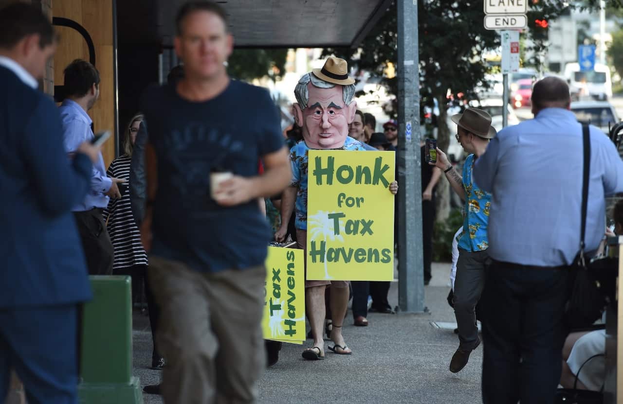 A man dressed up brandishes a sign during a Australian Prime Minister Malcolm Turnbull's visit to Brisbane (AAP)