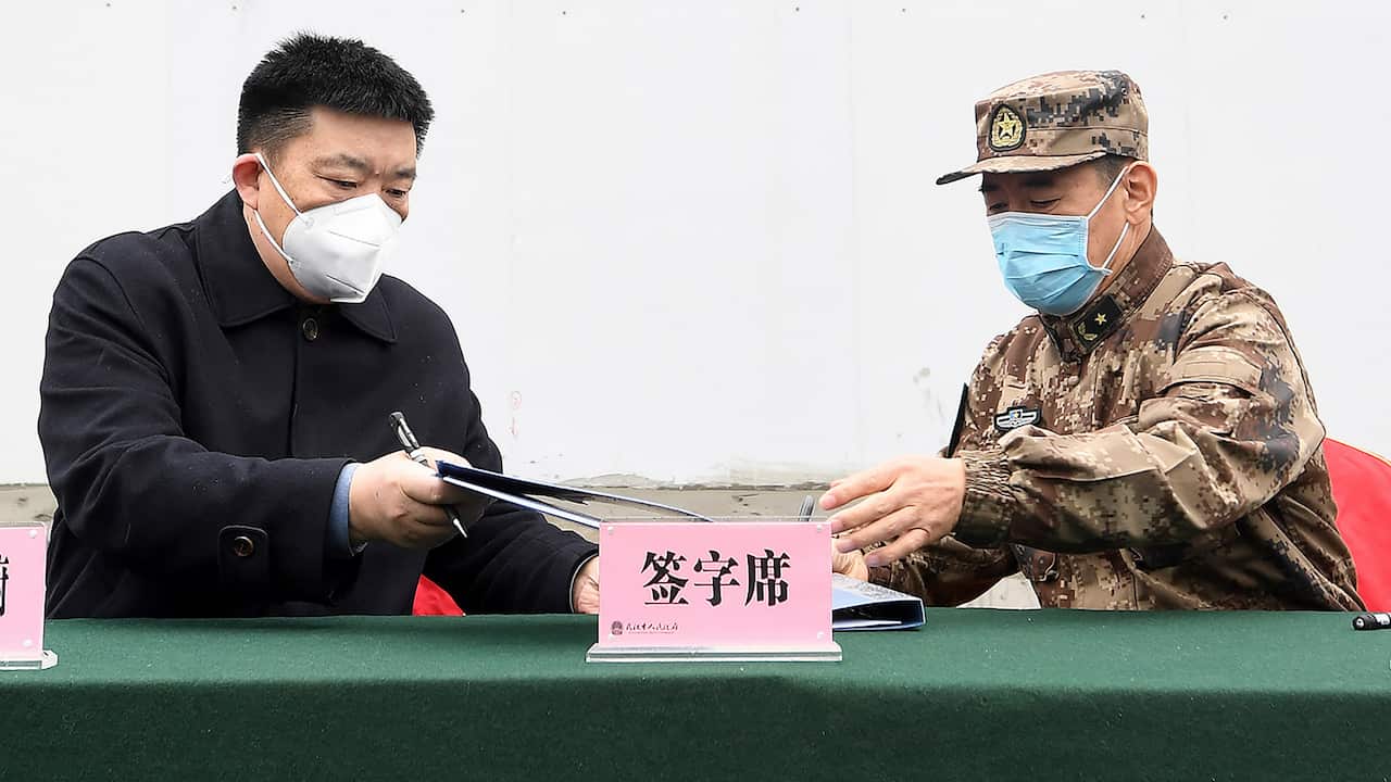 Wuhan mayor Zhou Xianwang (left) with Bai Zhongbin from China's People's Liberation Army at the Huoshenshan temporary field hospital.