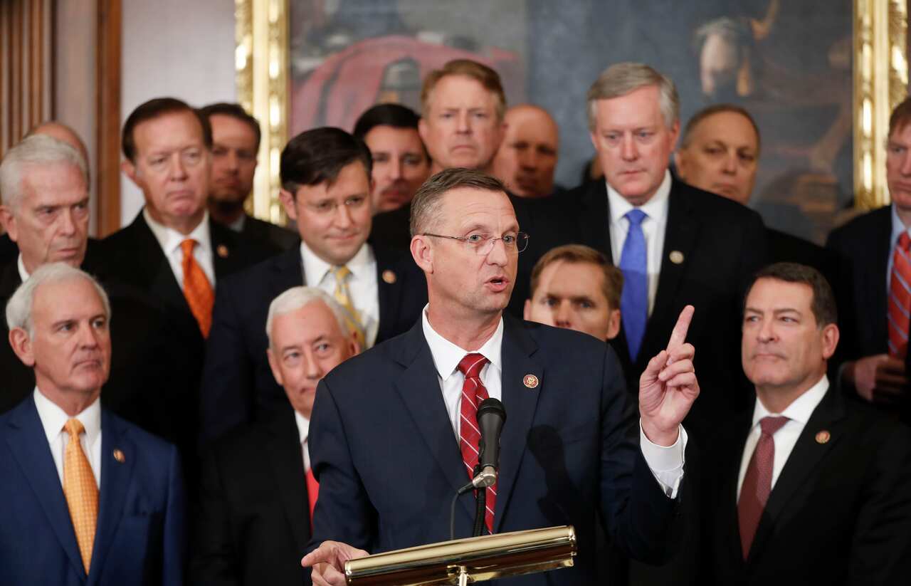 Rep. Doug Collins is joined by fellow Republican politicians  after Democrats pushed ahead a package of ground rules for their inquiry.