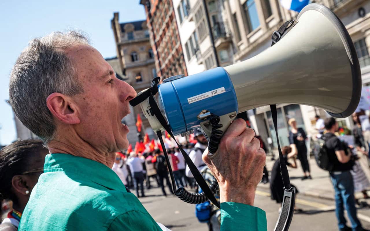 Human rights campaigner Peter Tatchell shouts into a megaphone during an LGBT rights protest.