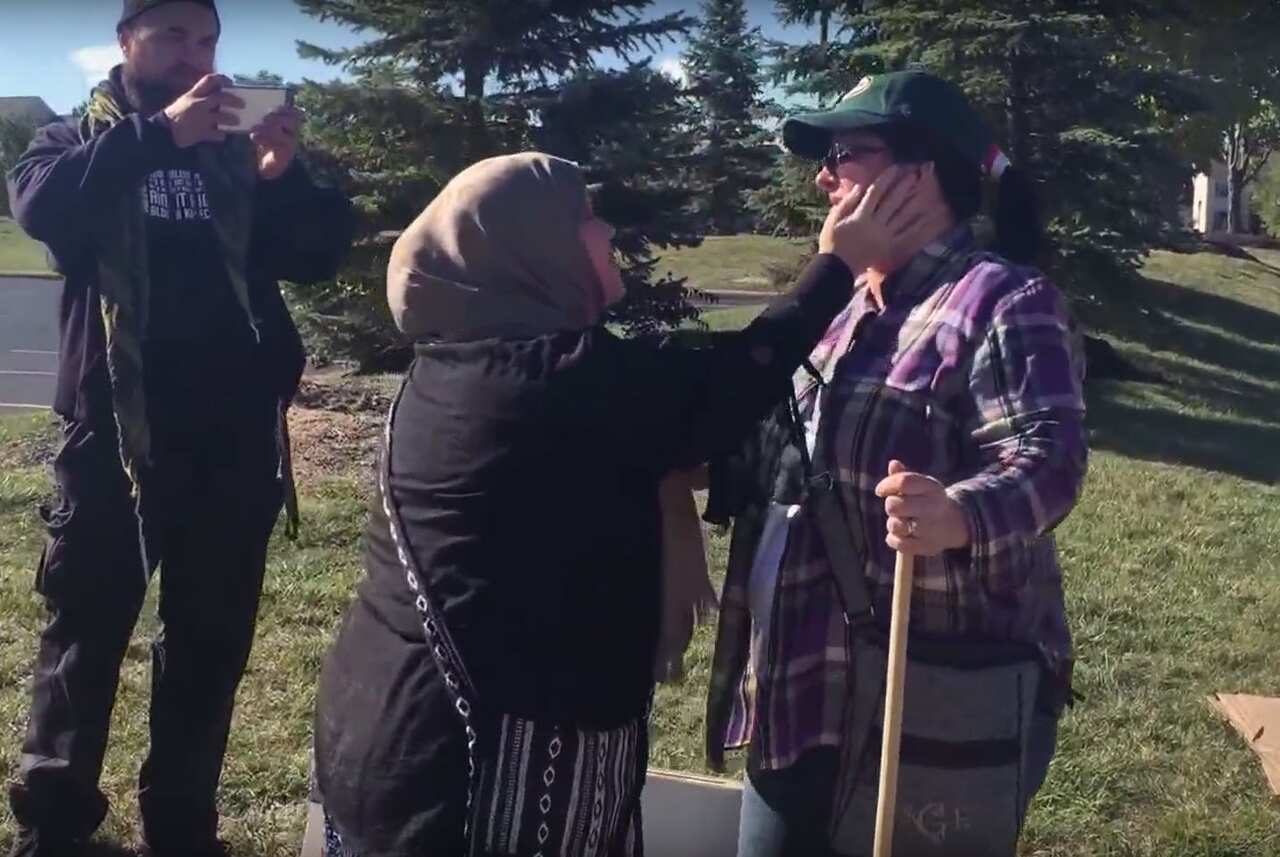 Muslim woman Cynthia DeBoutinkhar hugs anti-Muslim protester Annie out the front of Noor Islamic Cultural Center in Columbus, Ohio. 