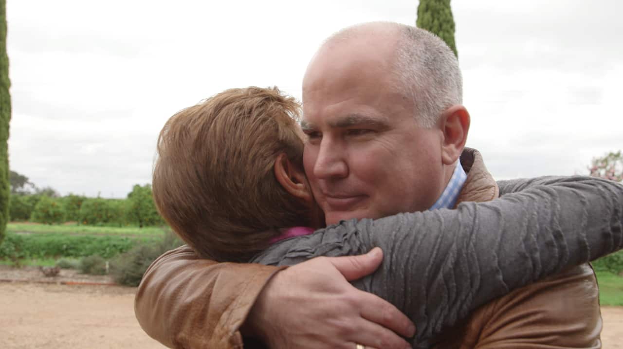 Life and death ... Professor Dominic Rowe is greeted by Joe Pasin's widow, Mim, at the farm they built together in the Riverina. 