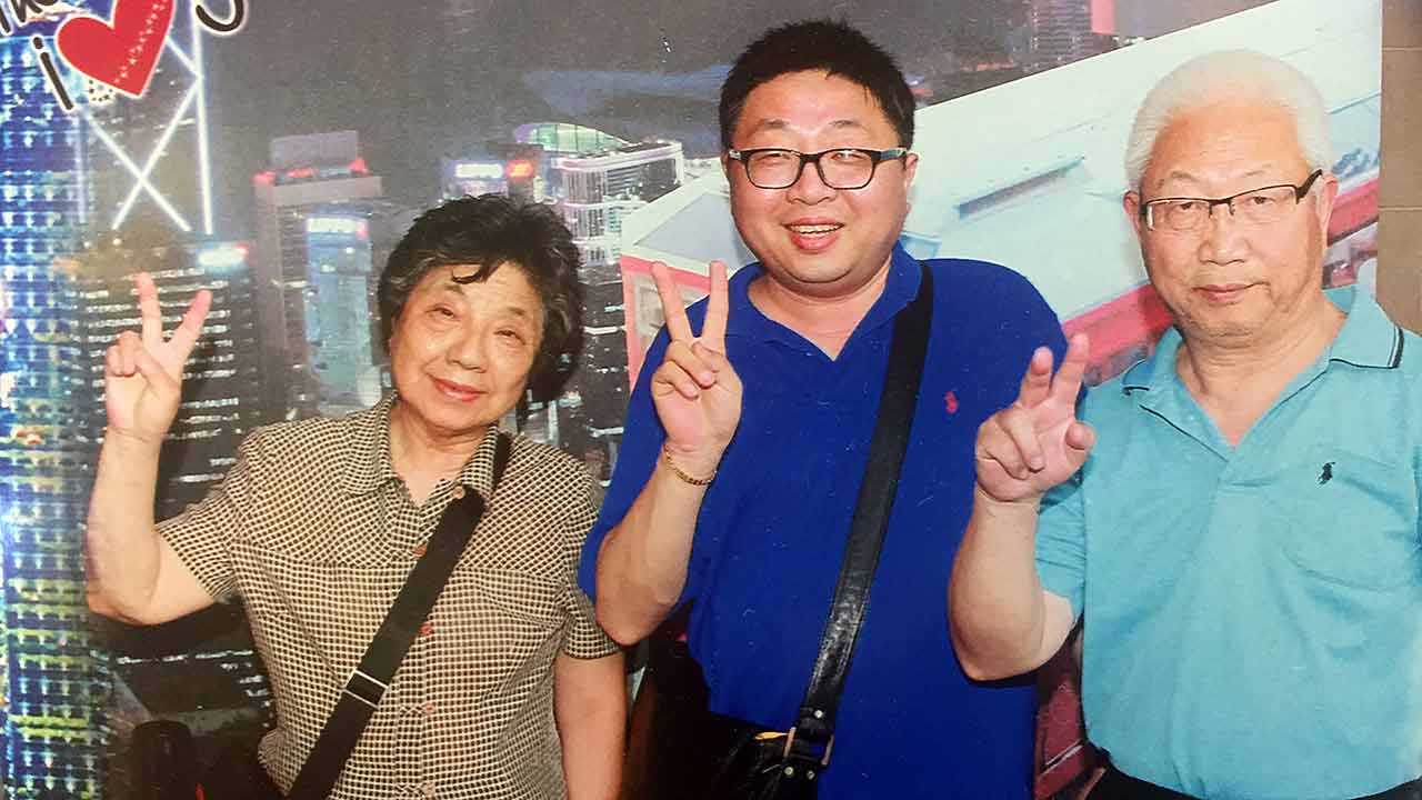 John Hugh with his mother and late father whose ashes he was returning to China.