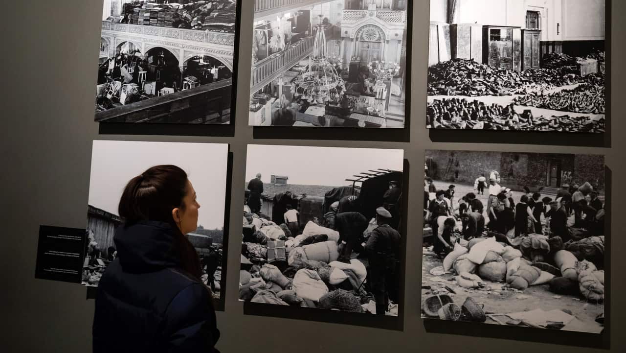 A visitor looks at black-and-white photographs in the Holocaust Memorial Center in Budapest, Hungary.