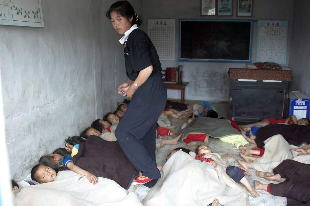 A file photo of malnourished children sleeping on the floor in a kindergarten in a rural cooperative 300km from the capital Pyongyang, Sunday, 06 June 2004