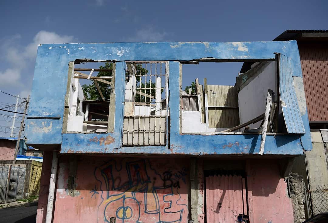 A house in the Figueroa neighborhood stands destroyed almost a year after Hurricane Maria hit.  