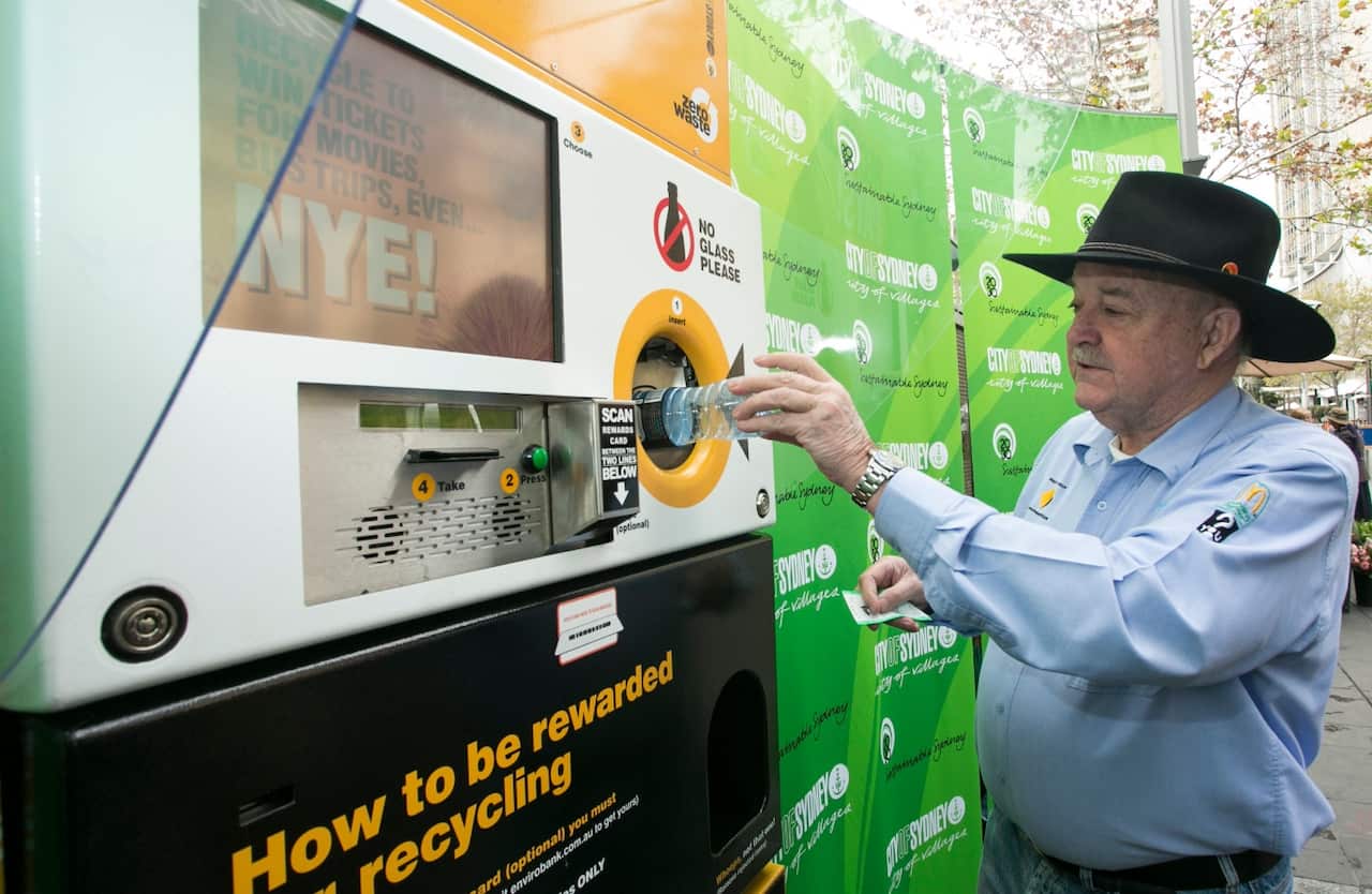 A supplied image obtained Monday, June 23, 2014 of Ian Keirnan of Clean Up Australia depositing a plastic bottle