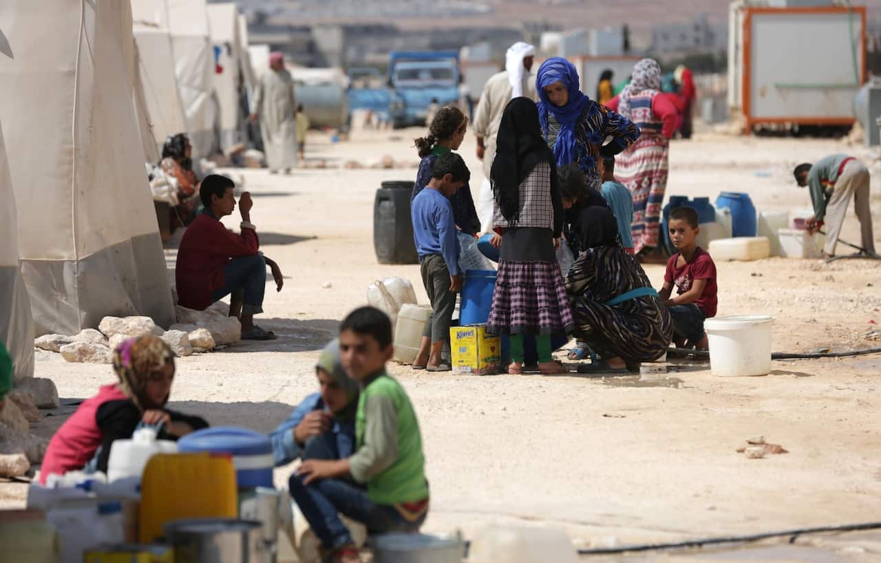 People who fled Syria's Idlib province are pictured at a camp in Kafr Lusin near the border with Turkey in the northern part of the province on September 9, 2018