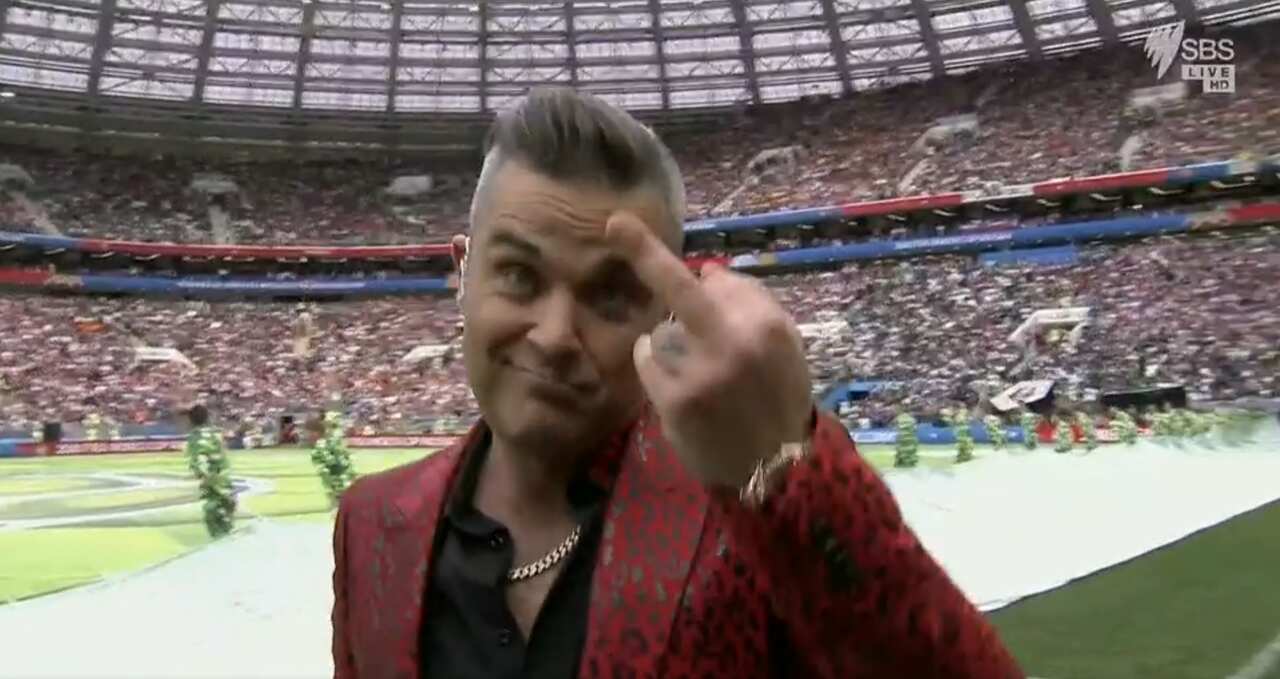 Robbie Williams signing off with an obscene hand  gesture.