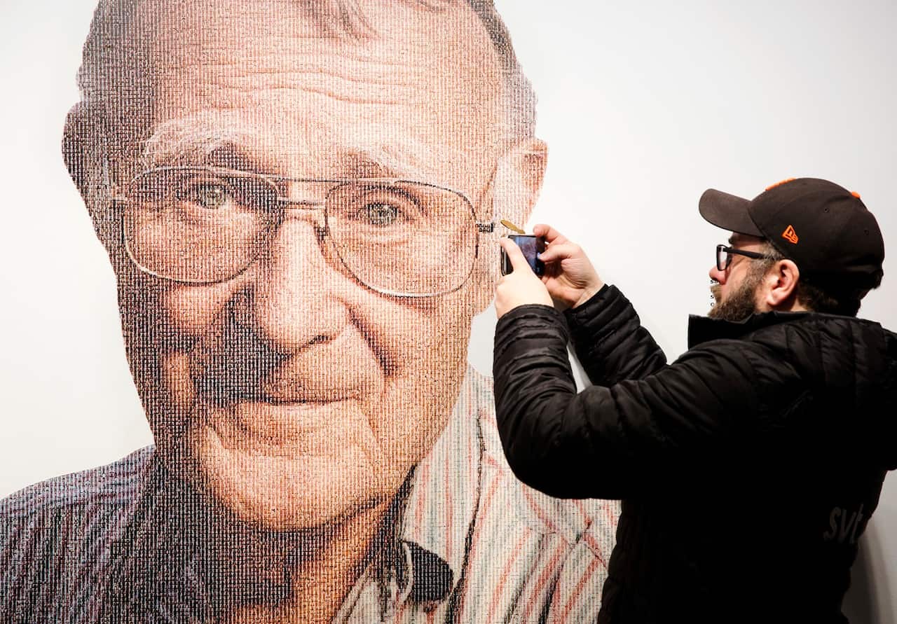 A visitor to the IKEA museum takes a mobile photo of a picture of Ingvar Kamprad, founder of Swedish multinational furniture retailer IKEA.