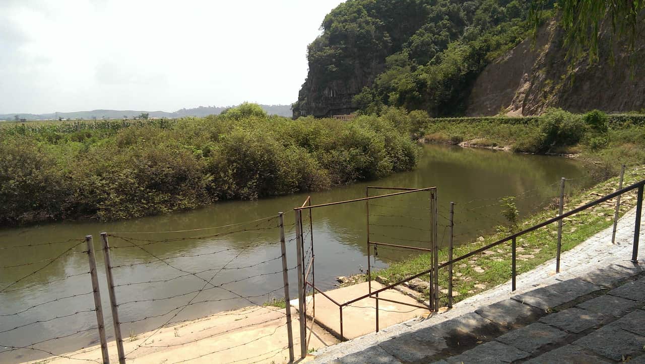 On the opposite river bank, only four metres away, innocuous shrubbery conceals another small barbed wire fence. That is North Korea. (Image: Elle Hardy)