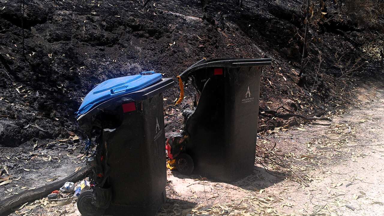 Plastic rubbish bins misshapen by the blaze. (Karen Ashford)