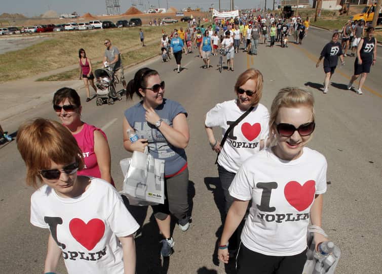In a 2012 ceremony, residents of Joplin, Missouri walk the route of a massive tornado that ripped through the town a year earlier, killing 161 people.