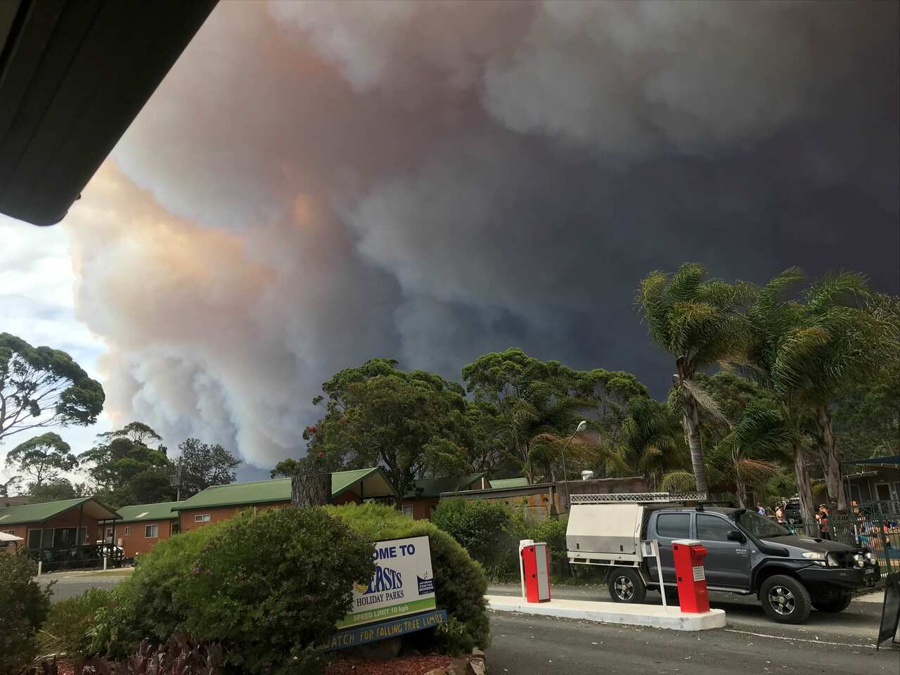 A bushfire cloud approaches Corrine East's holiday park in Moruya Heads.