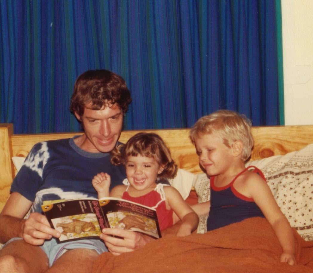 Roger Guard reads a storybook to his children Amanda and Paul.
