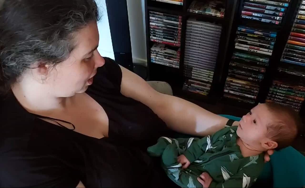 Cheryl holds her 12-week-old son Jeffrey during a CUBS therapy session.