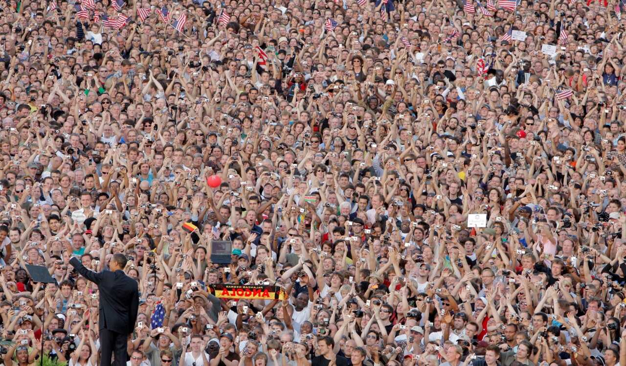 In this July 24, 2008 file photo, Barack Obama waves as he arrives at the Victory Column in Berlin.(AAP)