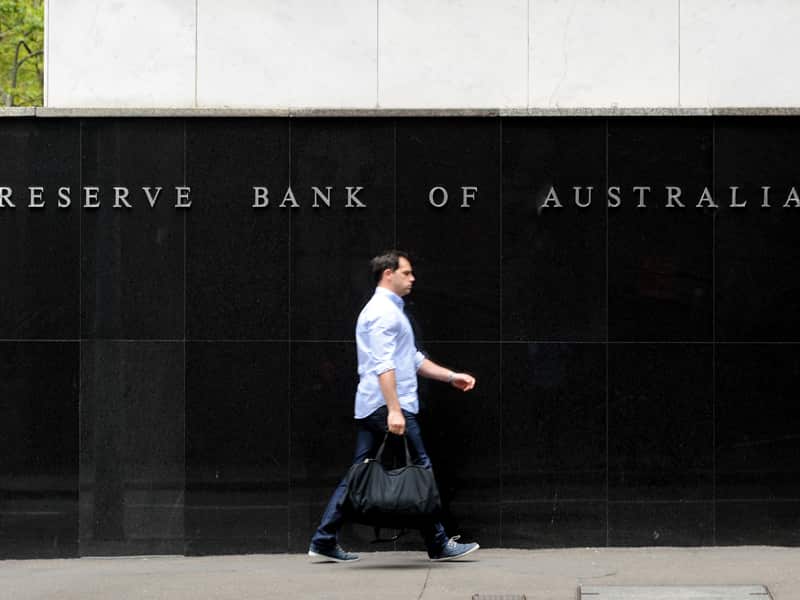 A person walks past the Reserve Bank of Australia headquarters