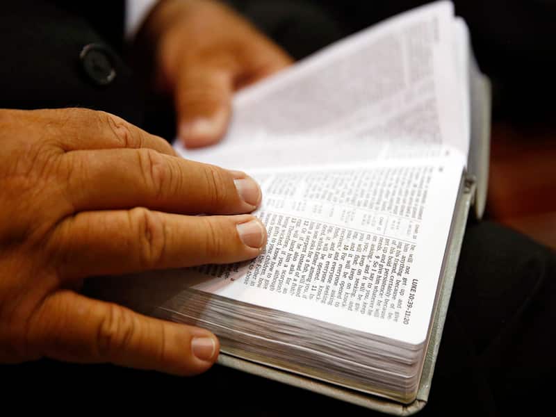 A congregation member reads a Bible