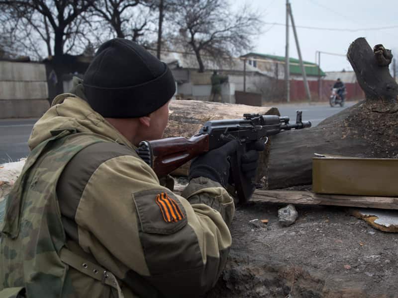 A pro-Russian rebel takes aim at a firing position at a check point
