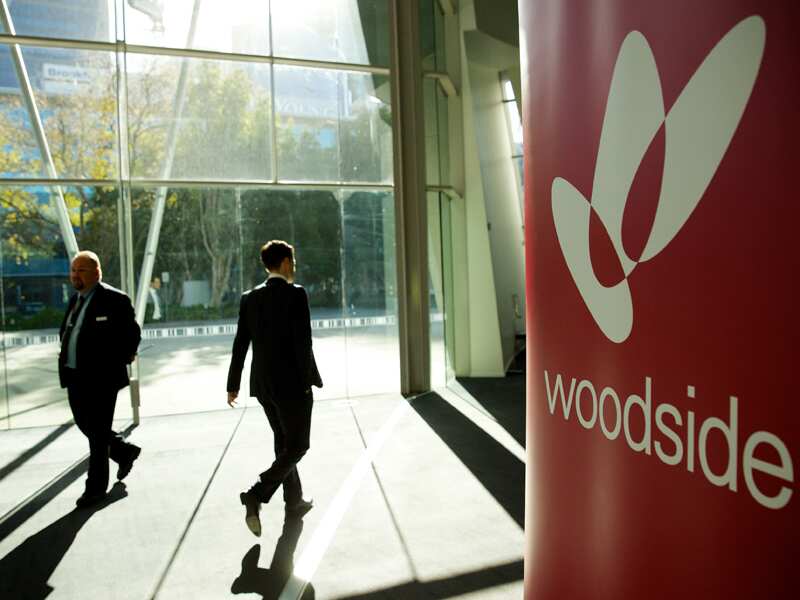 Shareholders walk into the Woodside AGM.