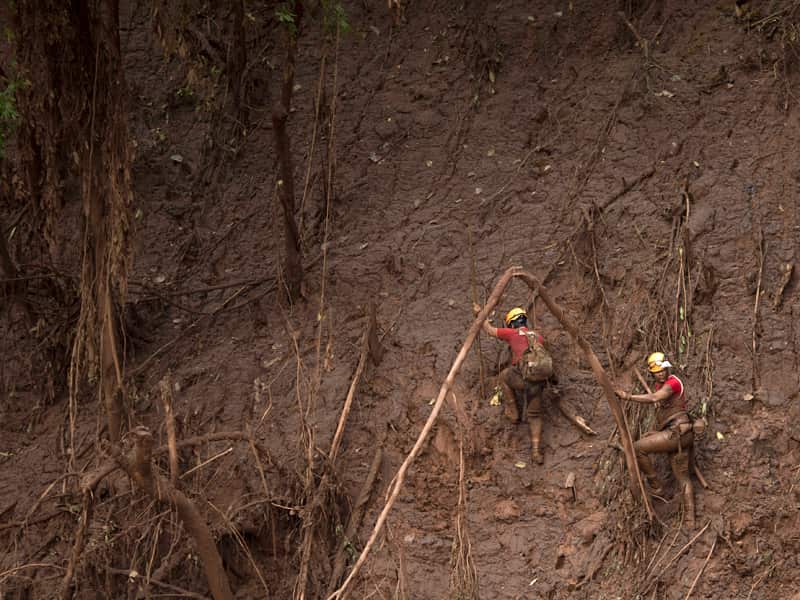 Rescue workers search for victims of a Brazilian mining accident
