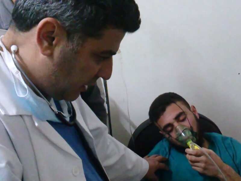 A Syrian man is seen receiving oxygen from a medic