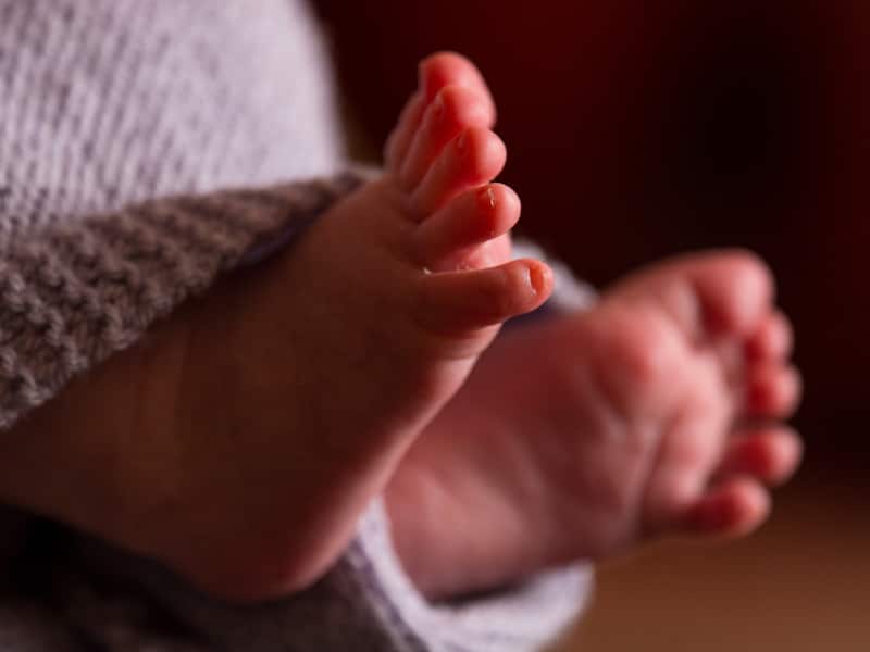 he feet of a new baby wrapped in a blanket