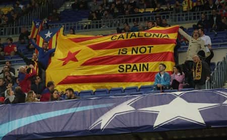 Pro-independence supporters hold a Catalan flag at the Camp Nou
