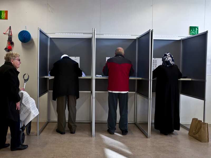 People fill out ballots prior to casting their votes